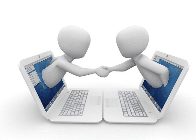 handshake extended out from two laptop screens | wordpress website | Peace Evolution