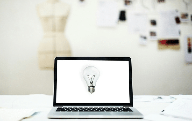 screen with lightbulb indicating ideas | small business | Peace Evolution