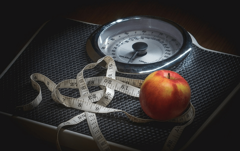 scale with tapemeasure and apple | autophagy healing | Peace Evolution