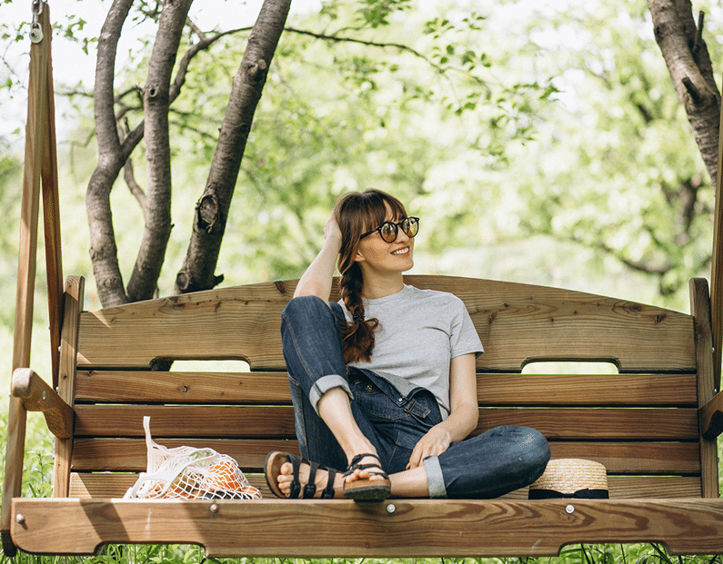 woman relaxing on a bench | eco friendly | Peace Evolution